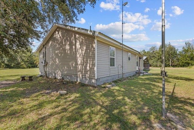 1439 W Lyman Hendry Rd, Perry, FL 32347 - view of side of home featuring a lawn