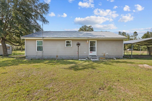 1439 W Lyman Hendry Rd, Perry, FL 32347 - rear view of property with entry steps, a carport, a lawn, and a metal roof