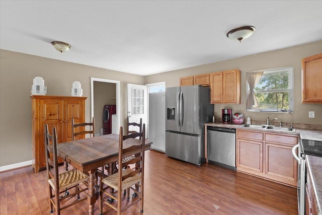 1439 W Lyman Hendry Rd, Perry, FL 32347 - kitchen featuring stainless steel appliances, wood finished floors, and light brown cabinets