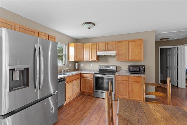 1439 W Lyman Hendry Rd, Perry, FL 32347 - kitchen featuring stainless steel appliances, under cabinet range hood, light countertops, wood finished floors, and light brown cabinetry