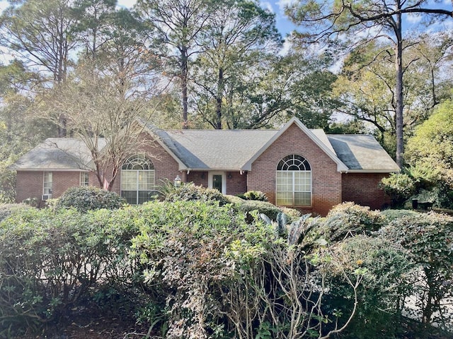 single story home featuring brick siding