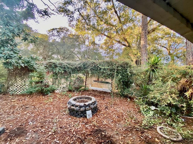 view of yard with an outdoor fire pit