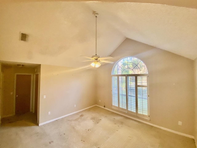 unfurnished room with light colored carpet, visible vents, vaulted ceiling, ceiling fan, and baseboards