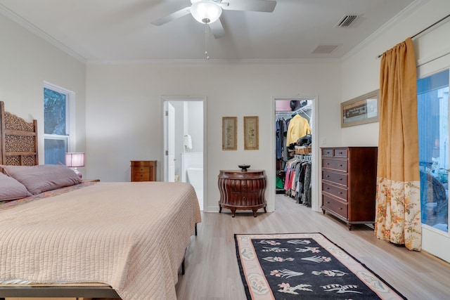 624 W 7th Ave, Tallahassee, FL 32303 - bedroom featuring ornamental molding, a walk in closet, light wood-type flooring, a closet, and ensuite bathroom
