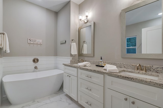 624 W 7th Ave, Tallahassee, FL 32303 - full bathroom with marble look tile flooring, double vanity, and a soaking tub