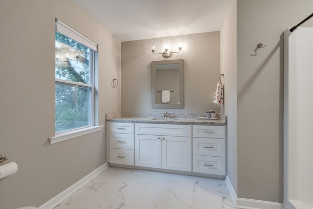 624 W 7th Ave, Tallahassee, FL 32303 - bathroom with marble look tiles, vanity, and plenty of natural light
