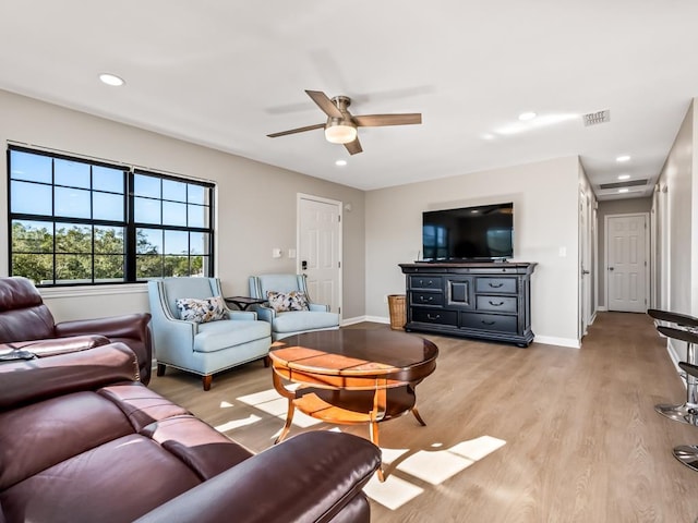 living room featuring light wood-type flooring and ceiling fan