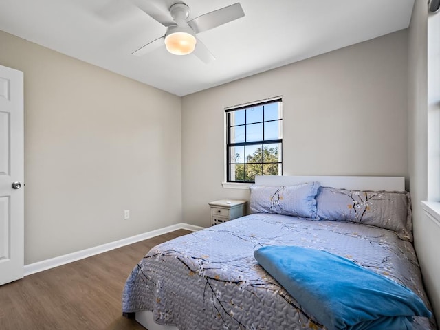 bedroom with dark hardwood / wood-style floors and ceiling fan