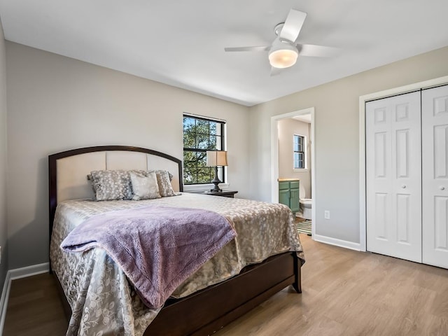 bedroom featuring ceiling fan, a closet, ensuite bathroom, and light hardwood / wood-style flooring