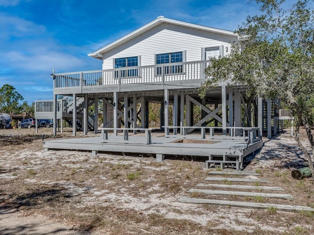 back of house featuring a deck