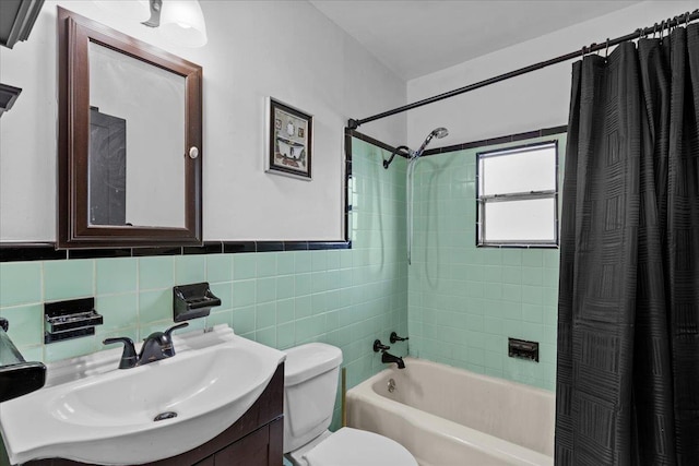 full bathroom with vanity, shower / bathtub combination with curtain, toilet, and tile walls