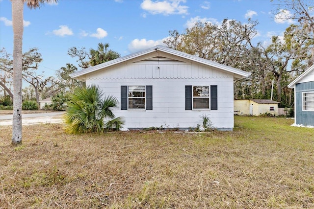 view of side of home featuring a lawn