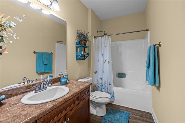 full bathroom featuring shower / bath combo with shower curtain, vanity, wood-type flooring, and toilet