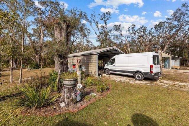 exterior space with a carport and a lawn