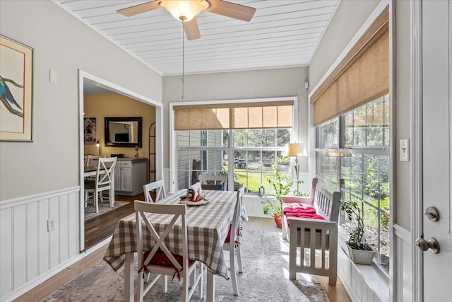 sunroom / solarium featuring ceiling fan and wood ceiling