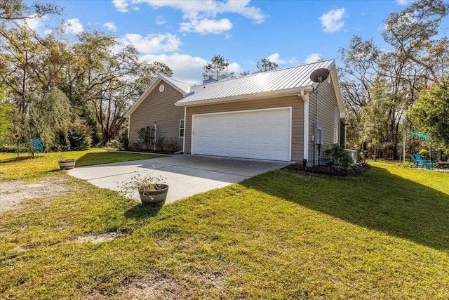 view of side of home featuring a lawn and a garage