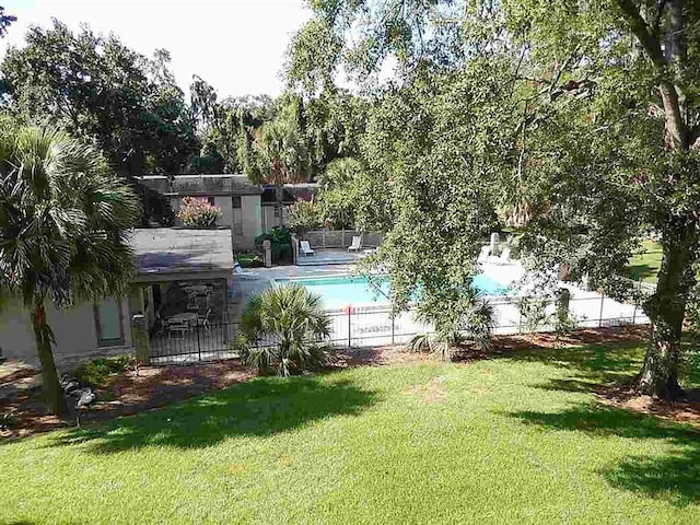 view of yard with a fenced in pool