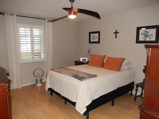 bedroom with ceiling fan and light hardwood / wood-style floors