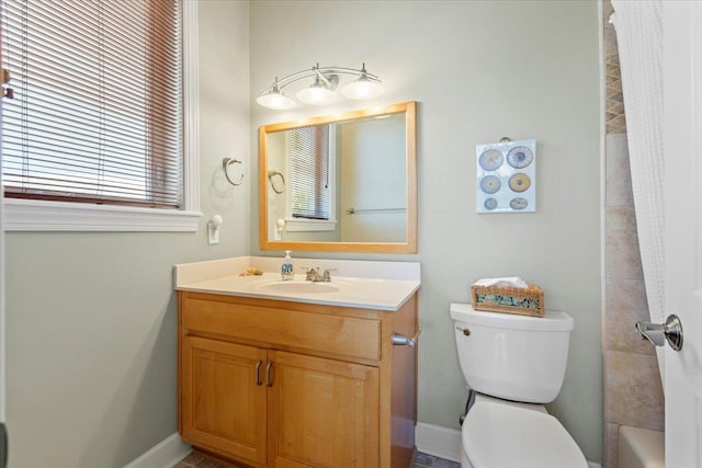 full bathroom featuring vanity, toilet, and tiled shower / bath