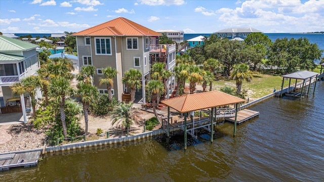 view of dock featuring a balcony and a water view