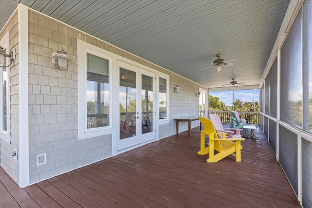 deck with ceiling fan, covered porch, and french doors