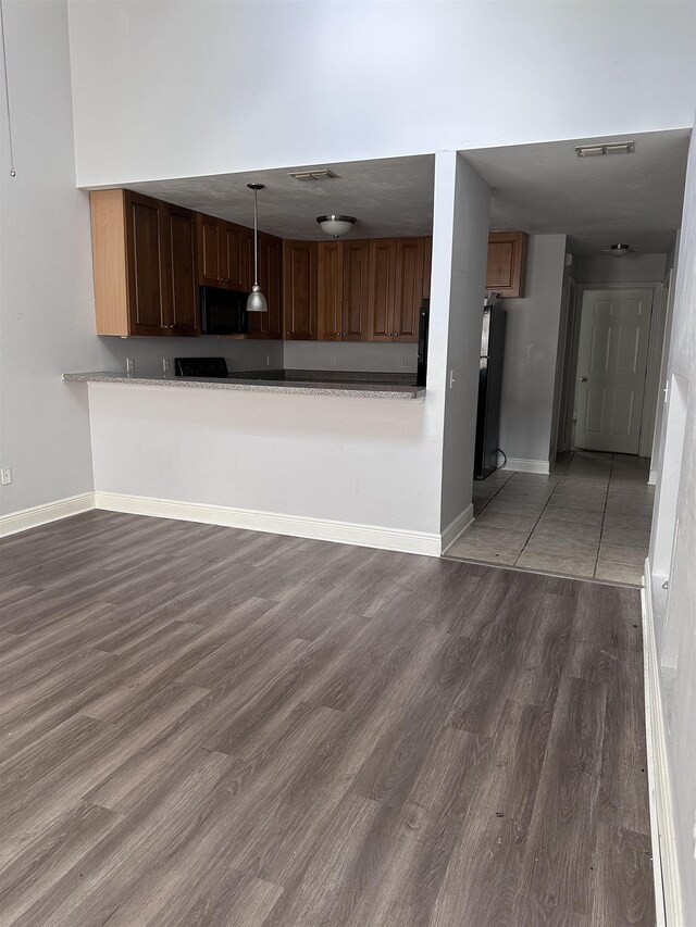 3340 Sugar Berry Way, Tallahassee, FL 32303 - kitchen featuring black microwave, wood finished floors, decorative light fixtures, and light countertops