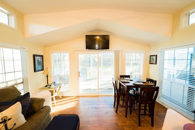 dining room featuring a wealth of natural light, lofted ceiling, and dark hardwood / wood-style floors