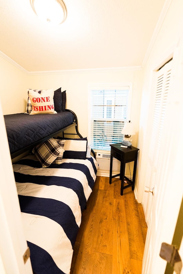 bedroom with dark wood-type flooring and crown molding