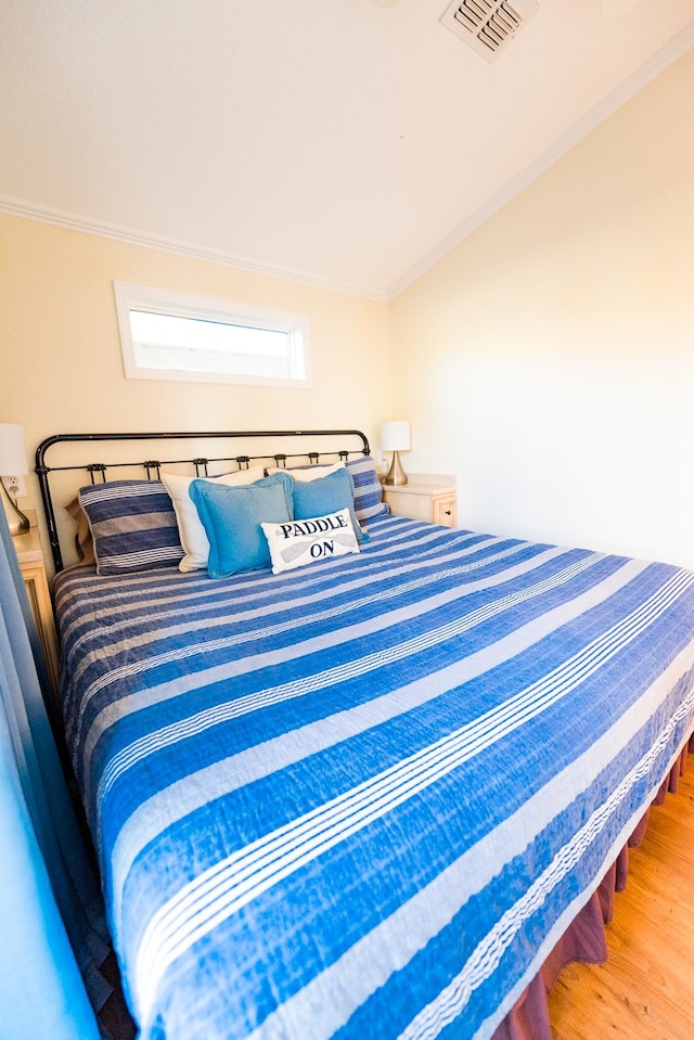 bedroom featuring hardwood / wood-style floors and ornamental molding