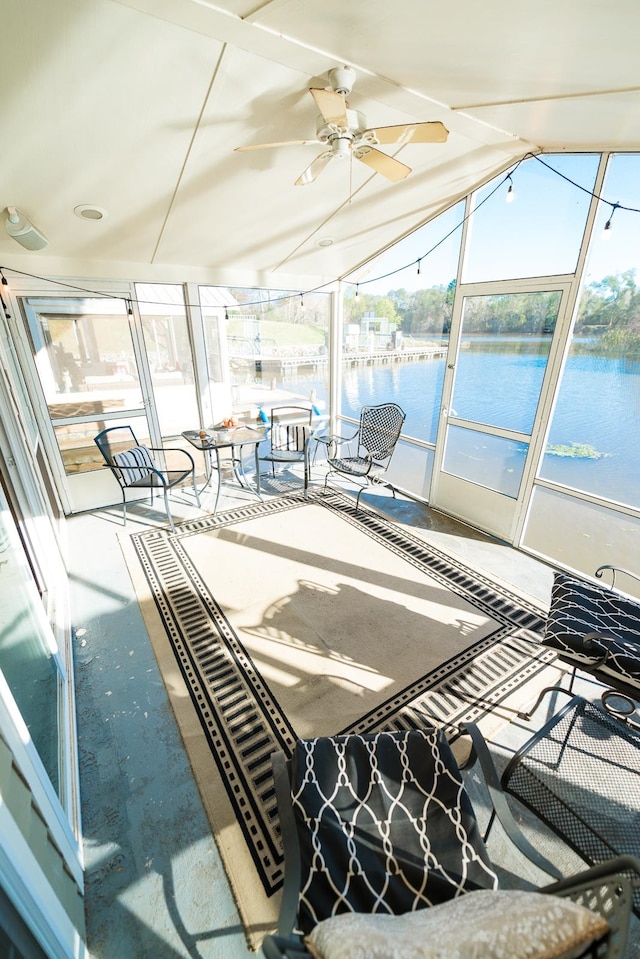 sunroom with a water view, ceiling fan, and lofted ceiling