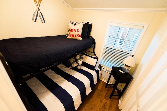 bedroom featuring dark wood-type flooring and ornamental molding