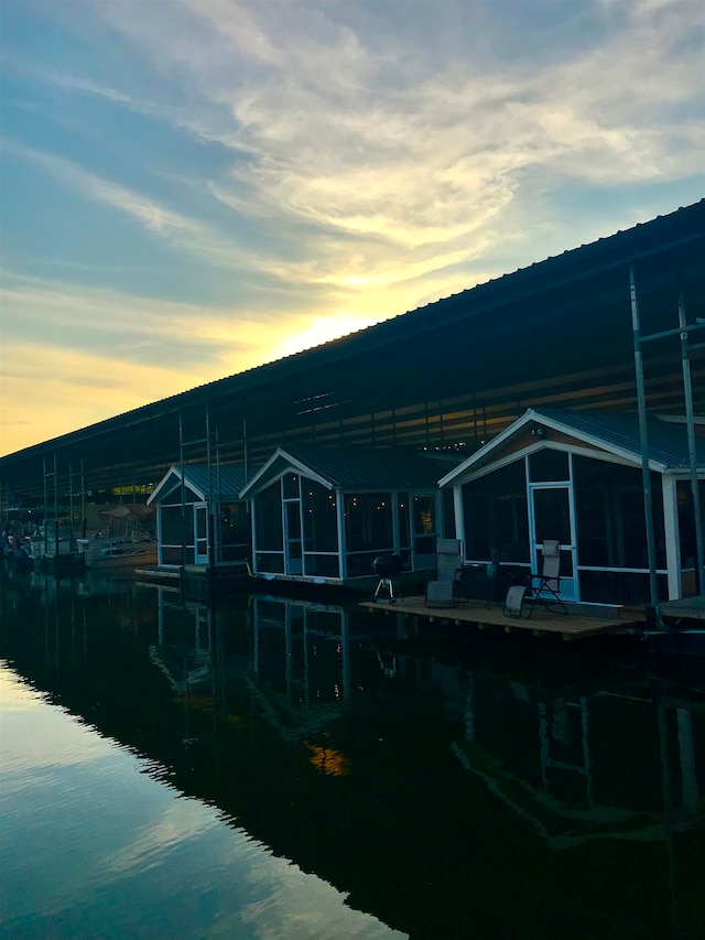 back house at dusk featuring a water view