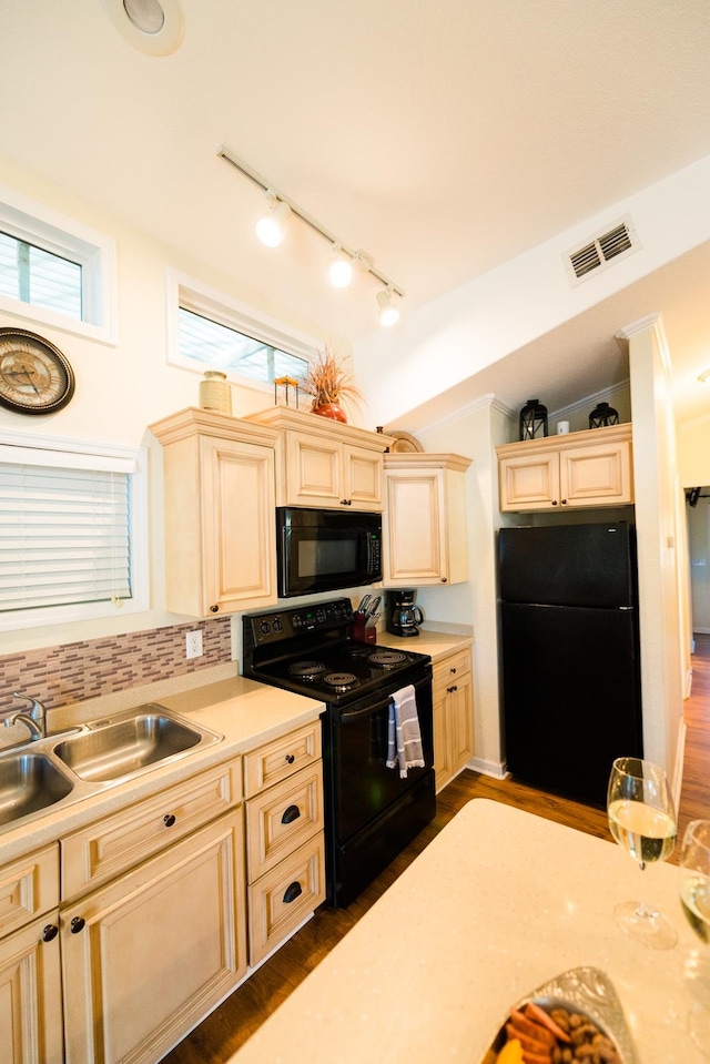 kitchen with black appliances, sink, decorative backsplash, dark wood-type flooring, and lofted ceiling