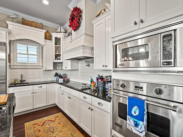 45 Walker Creek Dr, Shell Point, FL 32327 - kitchen with built in appliances, crown molding, custom range hood, white cabinetry, and recessed lighting