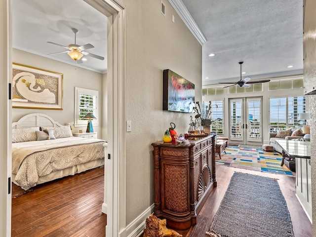 45 Walker Creek Dr, Shell Point, FL 32327 - bedroom with french doors, ornamental molding, wood-type flooring, a textured ceiling, and a textured wall