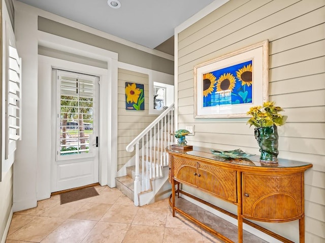 45 Walker Creek Dr, Shell Point, FL 32327 - foyer entrance featuring stairs, wood walls, and light tile patterned flooring