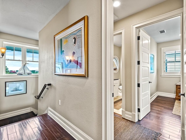 45 Walker Creek Dr, Shell Point, FL 32327 - hallway with dark wood-style flooring and a textured wall