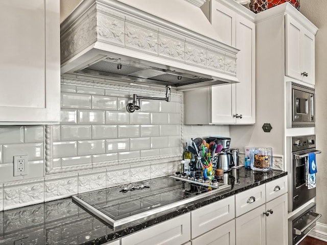 45 Walker Creek Dr, Shell Point, FL 32327 - kitchen with custom range hood, appliances with stainless steel finishes, white cabinetry, decorative backsplash, and a warming drawer