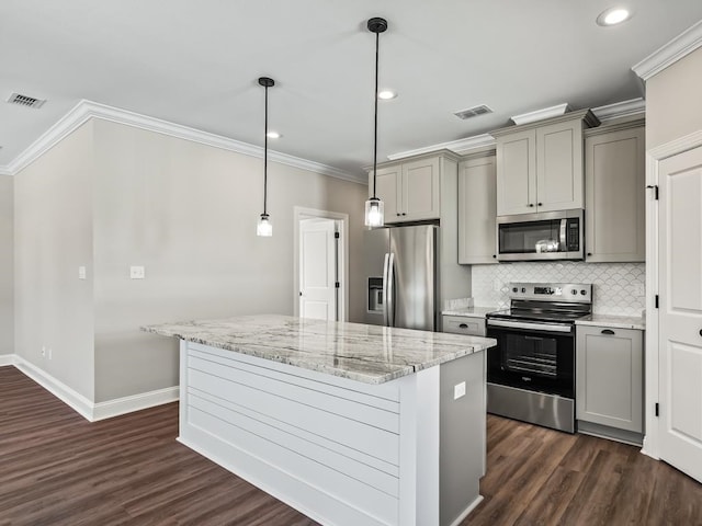 kitchen featuring stainless steel appliances, dark hardwood / wood-style flooring, light stone counters, gray cabinets, and decorative light fixtures