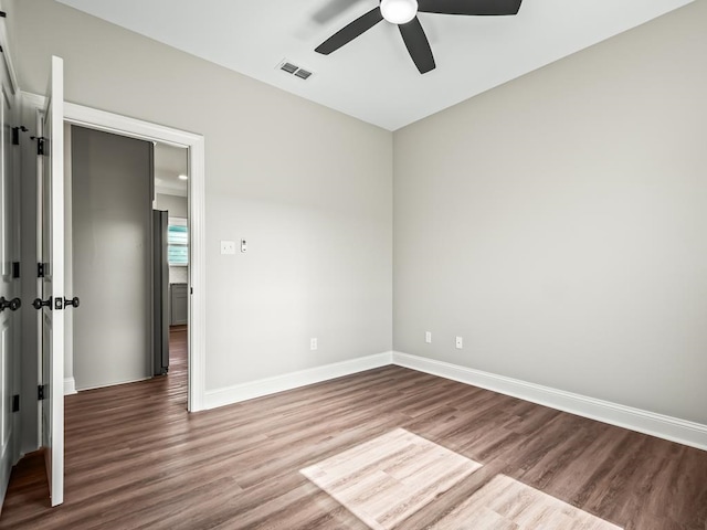 empty room featuring hardwood / wood-style flooring and ceiling fan