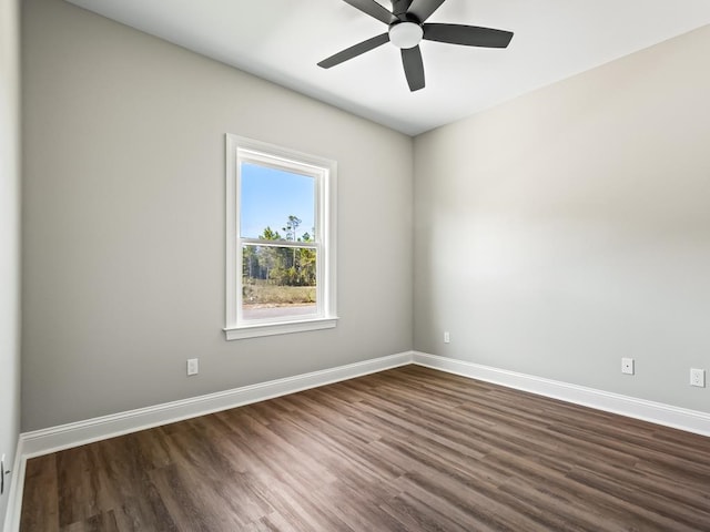 spare room with dark hardwood / wood-style flooring and ceiling fan