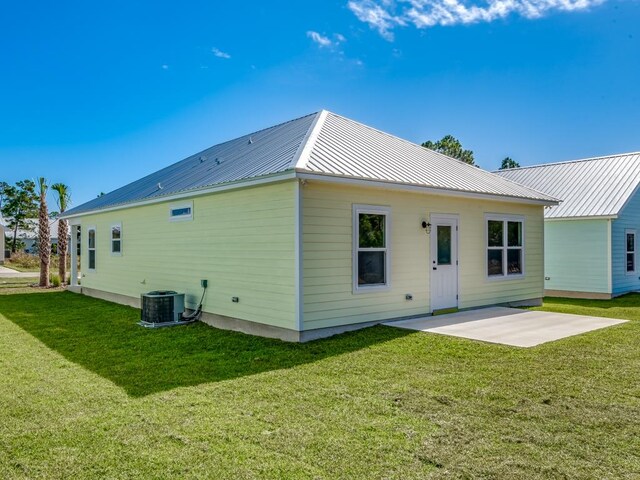 rear view of house with a lawn and a patio area