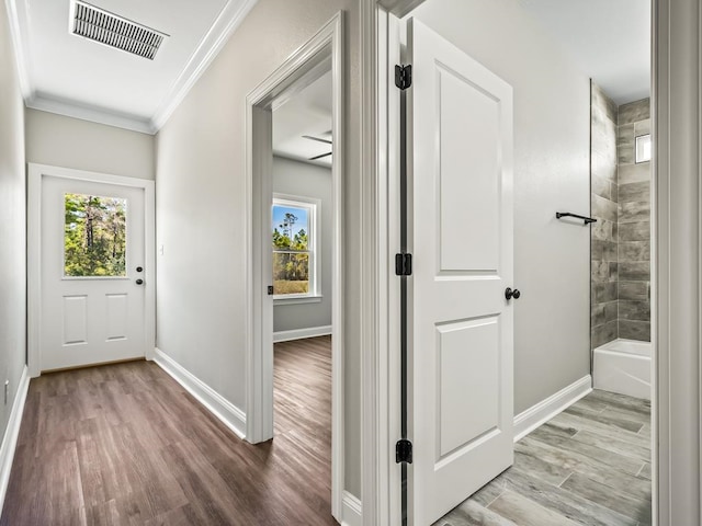 hallway featuring wood-type flooring and crown molding