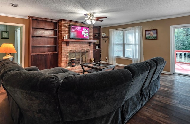 living room featuring dark hardwood / wood-style flooring, a textured ceiling, and a wealth of natural light