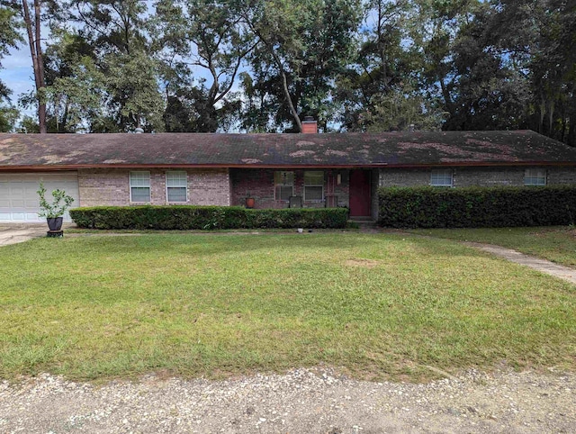 single story home with a garage and a front yard