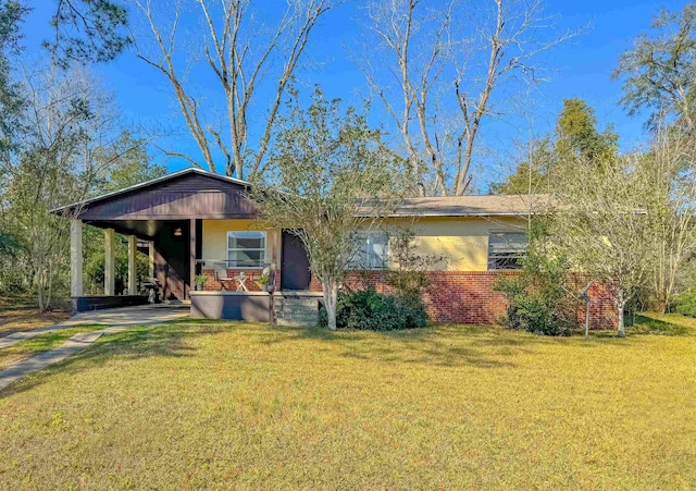 ranch-style house featuring brick siding, a porch, and a front yard