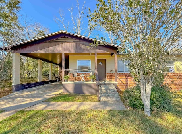 view of front of property with concrete driveway, a porch, and brick siding