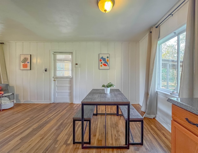 dining room featuring light wood-style flooring and baseboards