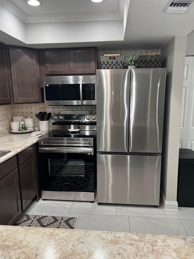 kitchen featuring backsplash, appliances with stainless steel finishes, dark brown cabinets, and crown molding