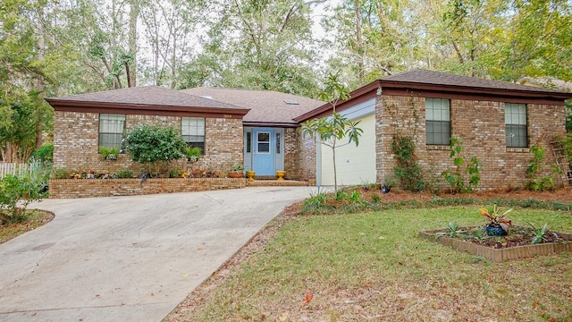 view of front of home with a garage and a front lawn